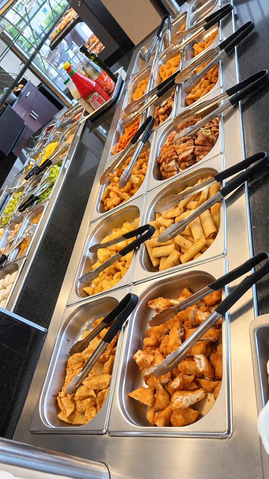 Buffet with spring rolls, fried dishes and other food