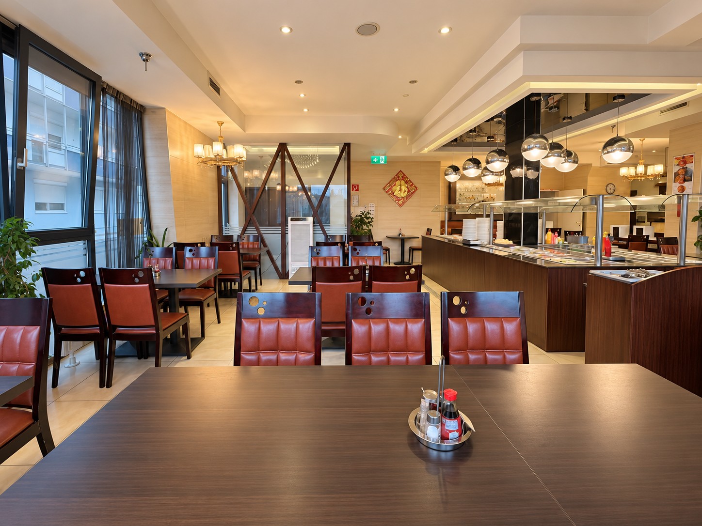 Dining room with dark tables, upholstered chairs and buffet area